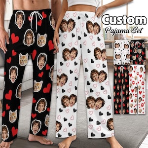 May include: Custom pajama pants in black and white, featuring repeating patterns of faces, hearts, and cat faces. The text "Custom Pajama Set" is visible in the upper right corner. The pants have a drawstring waist.