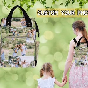 May include: A black and gray diaper bag with a custom photo design featuring multiple images of a family. The bag has a zippered closure and adjustable straps. The text "CUSTOM YOUR PHOTO" is displayed in yellow letters on a white background.
