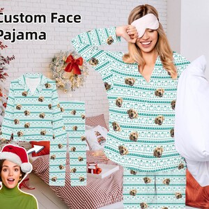May include: A white and green pajama set with a repeating pattern of a dog's face. The pajamas have a v-neck top and long pants. The text "Custom Face Pajama" is in the top left corner of the image.