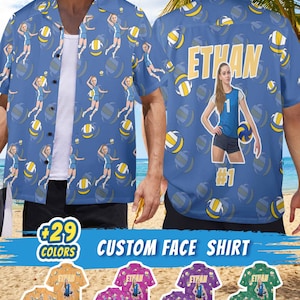 May include: A blue button-down shirt featuring a repeating pattern of volleyball players and volleyballs. The back displays the name ETHAN in large yellow letters above a large graphic of a volleyball player, the number 1, and the text #1.