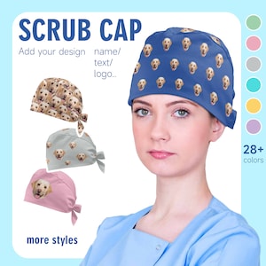 May include: A blue scrub cap with a pattern of dog faces. The cap is worn by a person with a blue surgical scrub top. The text "SCRUB CAP" is at the top of the image. The text "Add your design name/ text/ logo.." is below the cap. The text "more styles" is at the bottom of the image. The text "28+ colors" is in the bottom right corner of the image.