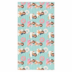 May include: A turquoise beach towel with a repeating pattern of people riding inflatable swans, flamingos, and donuts. The people's faces are replaced with a photo of a person.