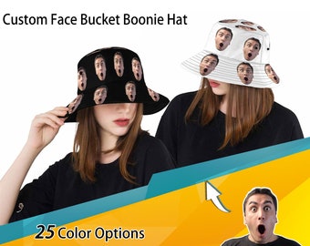 May include: Two people wearing custom face bucket hats. The hats feature a black and white design with multiple faces printed on them. The text "25 Color Options" is visible at the bottom of the image.