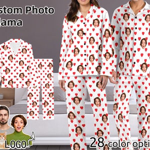 May include: Custom photo pajamas with a white background and red hearts. The pajamas feature a repeating pattern of hearts with a person's face in each heart. The text "Custom Photo Pajama" is at the top of the image. The text "28 color options" is at the bottom of the image.