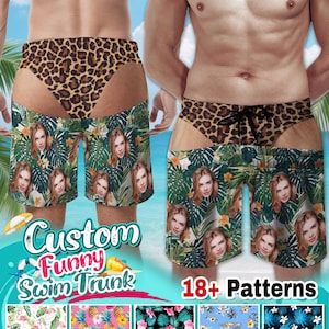 May include: Swim trunks featuring a leopard print waistband with a black drawstring and a lower section patterned with green tropical leaves, orange flowers, and repeated photographic portraits of a person. Includes text Custom Funny Swim Trunk.