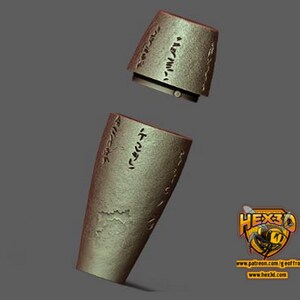 May include: Two pieces of a 3D printed, gold-colored, cylindrical object with an inscription of text. The object is made of a smooth, textured material.
