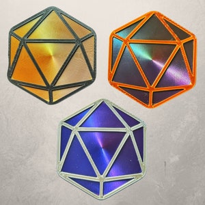 May include: Three iridescent dice with a geometric design. The dice are orange, purple, and blue.