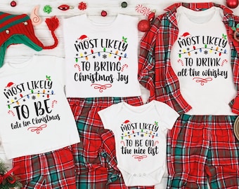 May include: A family Christmas pajama set featuring red and green plaid trousers and white tops. Each top displays a festive phrase: "Most Likely to Be Late for Christmas," "Most Likely to Bring Christmas Joy," "Most Likely to Drink all the Whiskey," and "Most Likely to Be on the Nice List."