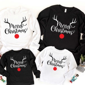 May include: Four long-sleeved shirts with the text "Merry Christmas" and reindeer antlers. Two shirts are white with black text and two shirts are black with white text.