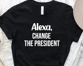 May include: Black t-shirt with white text that reads "Alexa, change the president."