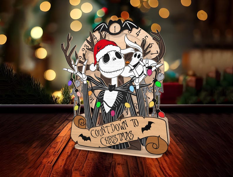 May include: A wooden Christmas countdown ornament featuring Jack Skellington from The Nightmare Before Christmas wearing a Santa hat and holding a Christmas light. The ornament has a scroll with the text "Count Down to Christmas".