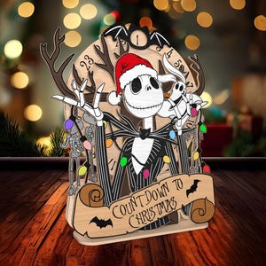 May include: A wooden Christmas countdown ornament featuring Jack Skellington from The Nightmare Before Christmas wearing a Santa hat and holding a Zero figure. The ornament has a scroll with the text "Count Down to Christmas".