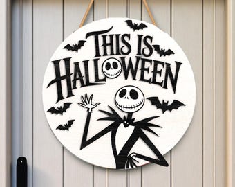 May include: A round, white wooden sign with the text "This is Halloween" in black, featuring Jack Skellington and bat silhouettes. The sign is designed for Halloween decor and hangs by a rope.