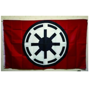May include: A red flag with a white circle and a black symbol in the center. The symbol is a circle with eight spokes radiating from the center.