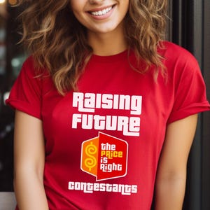 May include: A white ceramic mug with a black handle and the text "But First, Coffee" in a bold, black font. The mug is set against a blurred background, suggesting a cozy setting.