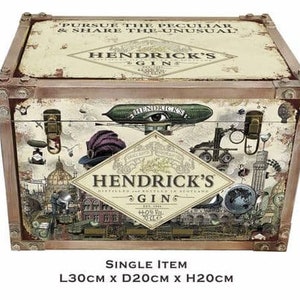 May include: A vintage-style wooden box with a distressed finish. The box features a colorful illustration of a whimsical scene with a flying airship, a clock, and a bottle of Hendrick's Gin. The text on the box reads "Pursue the Peculiar & Share the Unusual" and "Hendrick's Gin". The box measures 11.8 inches long, 7.9 inches deep, and 7.9 inches high.