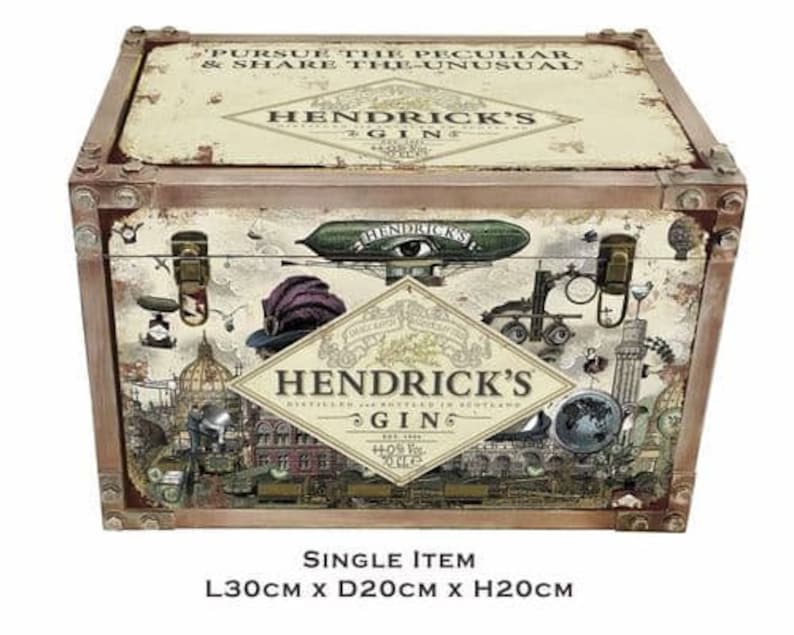 May include: A vintage-style wooden box with a distressed finish. The box features a colorful illustration of a whimsical scene with a flying airship, a clock, and a bottle of Hendrick's Gin. The text on the box reads "Pursue the Peculiar & Share the Unusual" and "Hendrick's Gin". The box measures 11.8 inches long, 7.9 inches deep, and 7.9 inches high.