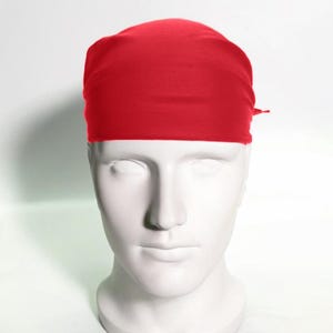 May include: A solid red bandana, folded and tied around a mannequin's head.