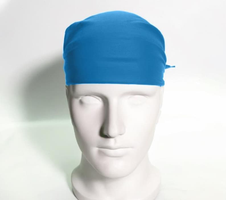 May include: A solid blue bandana tied around a mannequin's head. The bandana is made of a soft, smooth fabric.