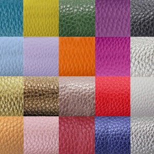 May include: A collection of 20 different colored leather swatches. The swatches are arranged in a grid of four rows and five columns. Each swatch is a different color, including blue, green, purple, orange, yellow, pink, red, brown, and gray.