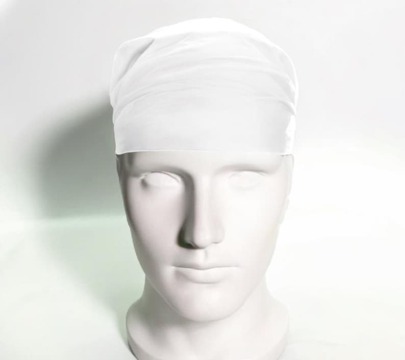 May include: White surgical cap made of a thin, breathable fabric. The cap is designed to cover the hair and keep it out of the way during medical procedures.