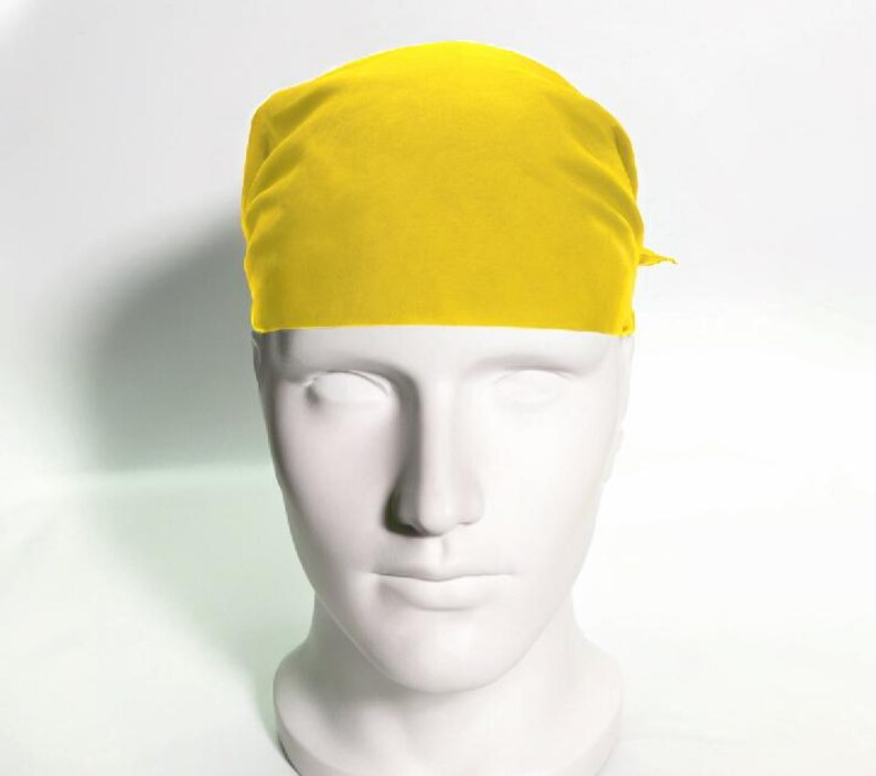 May include: A bright yellow bandana made of fabric. The bandana is tied around the head of a white mannequin.