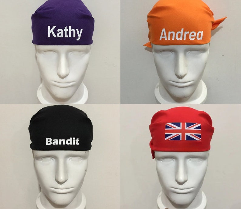 May include: Four different headbands with various designs. The first headband is purple with the name "Kathy" embroidered in white. The second headband is orange with the name "Andrea" embroidered in white. The third headband is black with the word "Bandit" embroidered in white. The fourth headband is red with a Union Jack flag design.