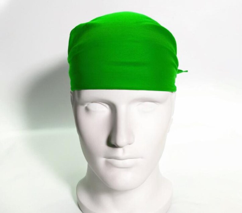 May include: A bright green bandana made of a soft, smooth fabric. The bandana is folded and tied around a mannequin's head.