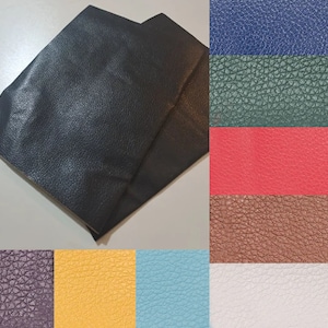 May include: A selection of faux leather swatches in various colours, including black, navy blue, green, red, brown, purple, yellow, blue, and white.