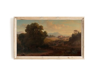 Puede incluir: Una pintura de paisaje enmarcada que representa una escena rural con un pueblo en la distancia, un camino sinuoso y un gran árbol en primer plano. El cielo es de un azul suave con nubes esponjosas, y el sol se pone en la distancia. La pintura está en un marco de madera claro.