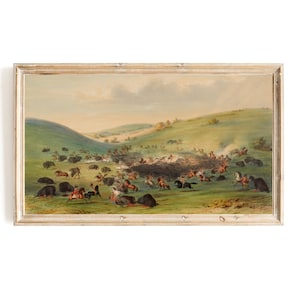 May include: A vintage painting depicting a scene of Native Americans on horseback hunting buffalo in a grassy valley. The painting is framed in a light wood frame.