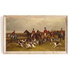 May include: A vintage oil painting depicting a group of riders on horseback, dressed in red coats and black hats, with a pack of hounds running in front of them. The painting is set in a rural landscape with a cloudy sky.