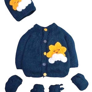 May include: A blue knitted baby sweater set with a yellow star and cloud design. The set includes a hat, sweater, booties, and mittens.