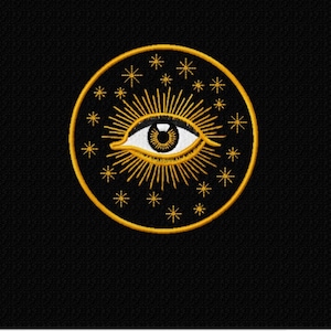 May include: A gold eye with a white iris and pupil surrounded by a circle of gold stars on a black background.