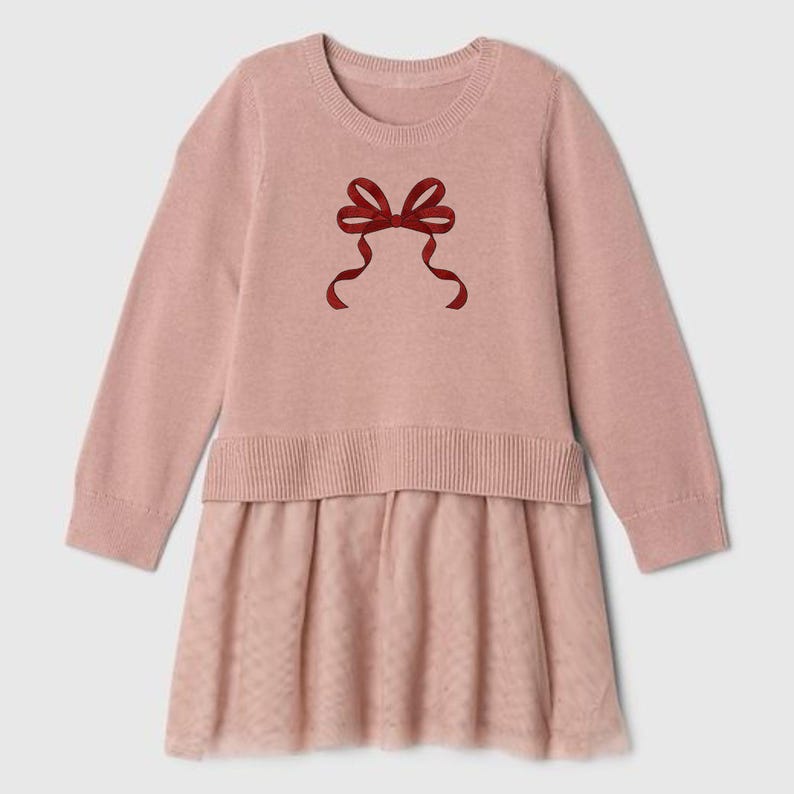 May include: A pale pink dress with long sleeves and a round neckline. The top is knitted, adorned with a red bow. The skirt is made of a sheer, dotted fabric. A stylish and comfortable outfit for any occasion.