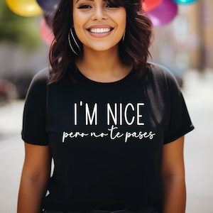 May include: A black t-shirt with white text that reads "I'm nice pero no te pases".