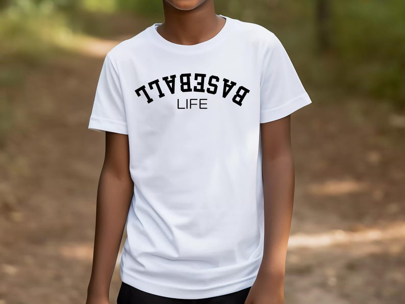 May include: White t-shirt with black text that reads "BASEBALL LIFE" in an arched font.
