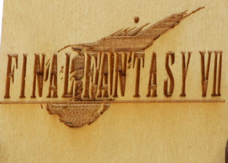 May include: A wooden carving of the "Final Fantasy VII" logo. The logo features the game's title in a stylized font, with a detailed illustration above. The carving is in shades of brown.