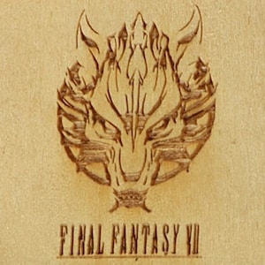 May include: A wooden carving featuring the wolf emblem from Final Fantasy VII. The emblem is intricately detailed, with sharp lines and a textured appearance. The text "FINAL FANTASY VII" is carved below the emblem.