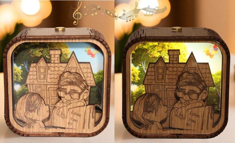 May include: Wooden light box featuring a laser-cut design of a couple kissing in front of a house, with the text "Love You" on a book. The box has a warm, inviting glow, and the design is reminiscent of a classic animated film.