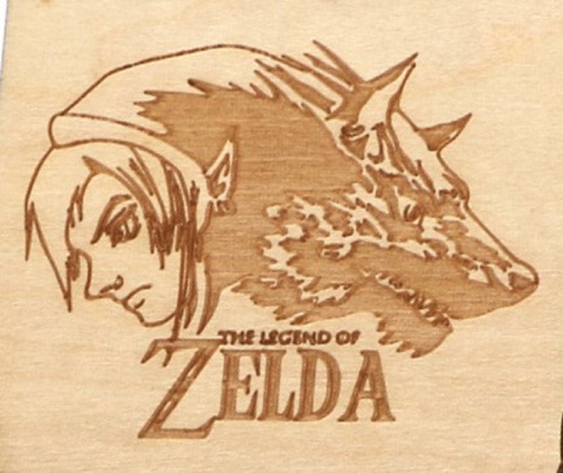 May include: A wood-burned image featuring a character from The Legend of Zelda, alongside a wolf. The text "THE LEGEND OF ZELDA" is below the image. The artwork is in shades of brown and tan.