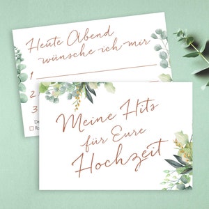 May include: Two white cards with a floral design. The top card has the text "Heute Abend w&uuml;nsche ich mir" and numbered lines for writing. The bottom card has the text "Meine Hits f&uuml;r Eure Hochzeit".