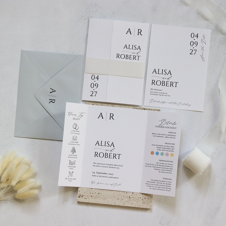 May include: Wedding invitation suite with white background and black text. The invitation features the names Alisa and Robert with the date 04.09.2027. The RSVP card includes details about the wedding ceremony and reception.
