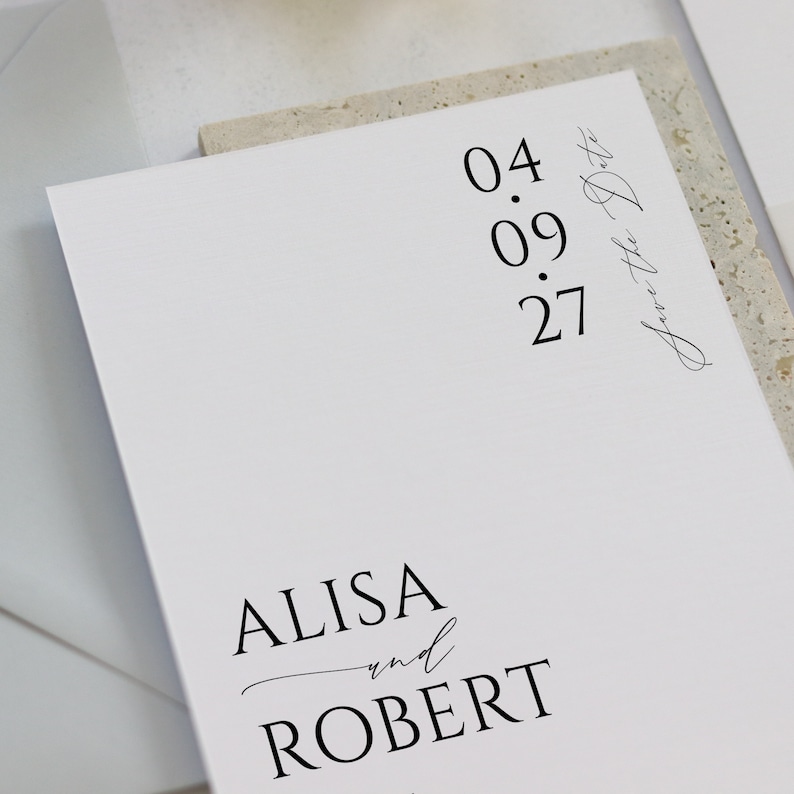 May include: Save the Date card with the date 04.09.27 and the names Alisa and Robert.