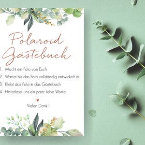 Peut inclure: Une carte blanche avec des bordures florales vertes et le texte "Polaroid G&auml;stebuch" en lettres brunes. La carte contient des instructions pour un livre d'or Polaroid&nbsp;: 1. Prenez une photo de vous, 2. Attendez que la photo se d&eacute;veloppe, 3. Collez la photo dans le livre d'or, 4. Laissez-nous quelques mots gentils. La carte se termine par "Vielen Dank!" en lettres brunes.