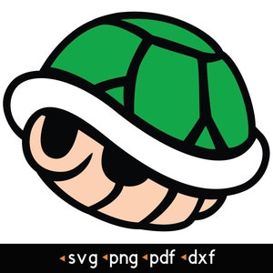 Può includere: Un guscio di tartaruga verde con un bordo bianco e un contorno nero. Il guscio è chiuso e ha un viso da cartone animato con gli occhi chiusi.