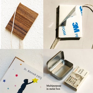 May include: A collection of items including a wooden bookmark with string, a 3M PE foam adhesive, a book with the text "Dr. BAHAR ERİŞ", and a small open metal box with a miniature book labeled "Unique Stuff Hidden Bookshelf".