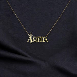 May include: Gold necklace with a sword pendant and the text "The Legend of Amelia".