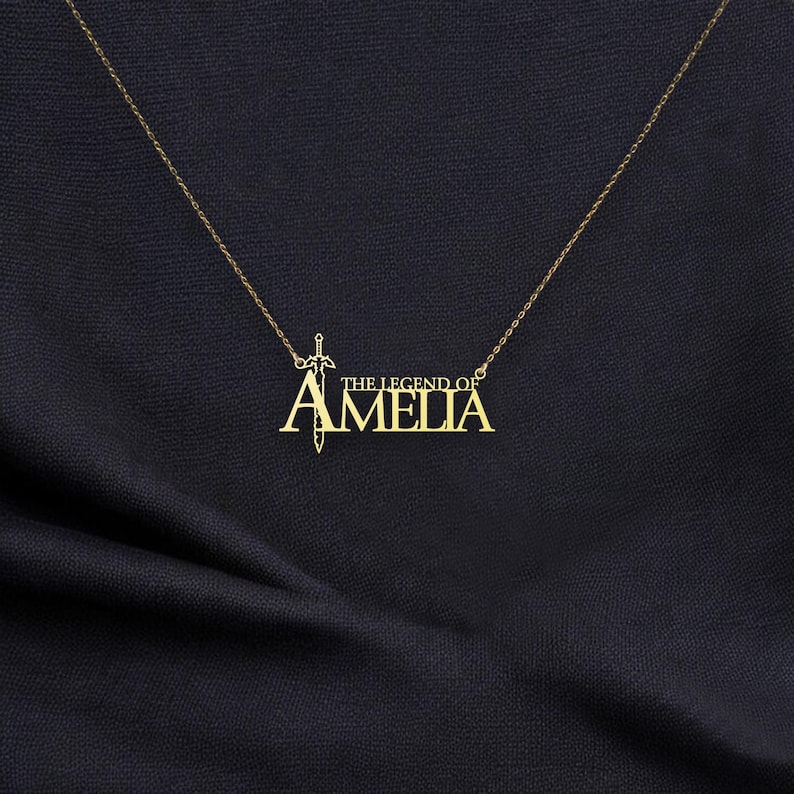 May include: Gold necklace with a sword pendant and the text "The Legend of Amelia".