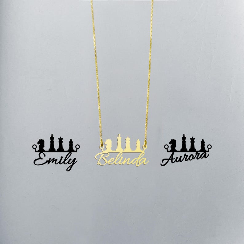 May include: Gold necklace featuring a chess piece design and the name "Belinda" written in cursive. The necklace is displayed against a white background with the names "Emily" and "Aurora" written in black below the necklace.